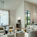 A view of a luxurious living, dining, and kitchen area with Lutron shades and lighting fixtures.